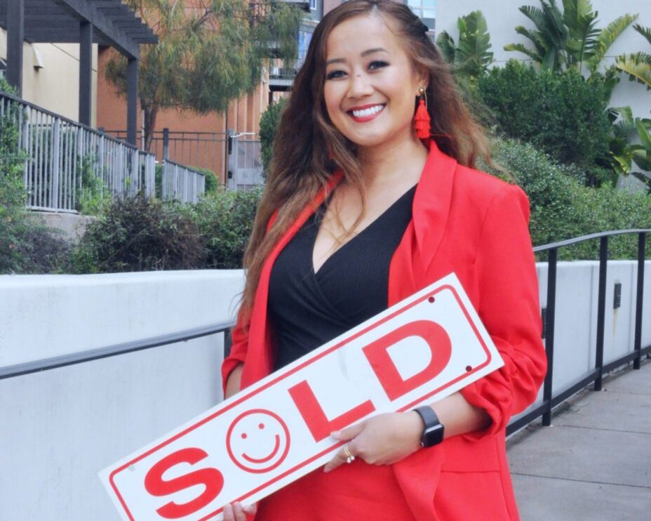 Jennifer Insisoulath holding a SOLD sign after closing a Bay Area listing